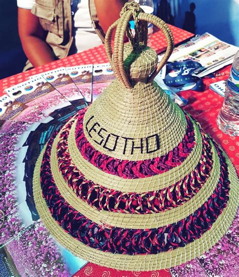 A Straw Hat With The Word Beth On It Sitting On Top Of A Round Table