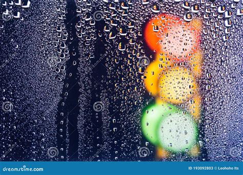Colorful Traffic Lights On The Rain Rain Drops On The Window Blurred