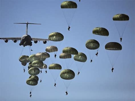 Us Army Paratroopers Jumping Out Of A C 17 Globemaster Iii Aircraft
