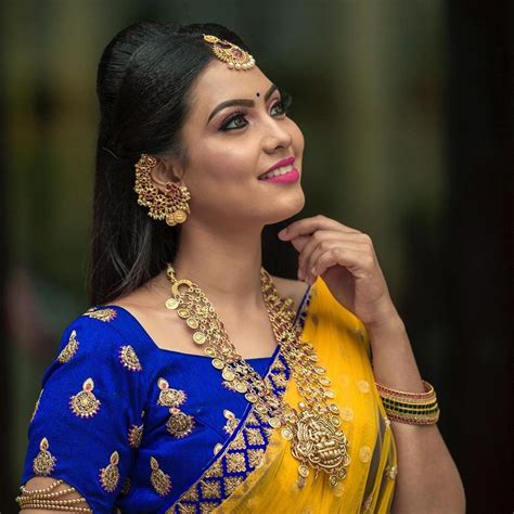 In A Bridal Look In A Yellow And Dark Blue Color Pattu Kanjeevaram Saree Short Sleeve Blouse