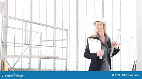 Woman Architect Or Construction Engineer Wear Helmet And Holds Folder