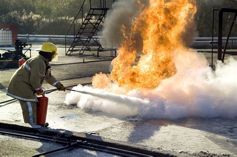 Firefighter Extinguishing A Fire Stock Image T6640279 Science
