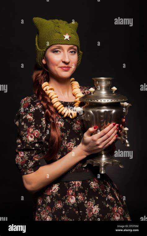 girl in soviet retro style posing with samovar girl with a green cap