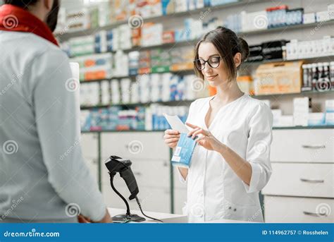 Pharmacist Selling Medications In The Pharmacy Store Stock Image