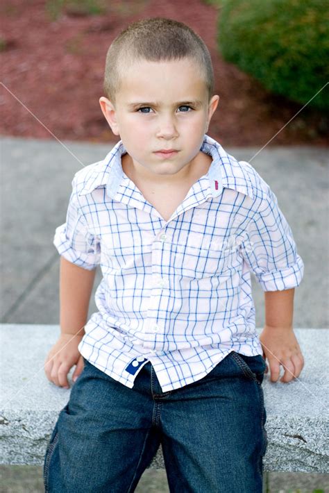 A Little Boy With A Serious Or Bored Expression On His Face Royalty