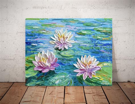 Two Water Lilies Floating On Top Of A Lake
