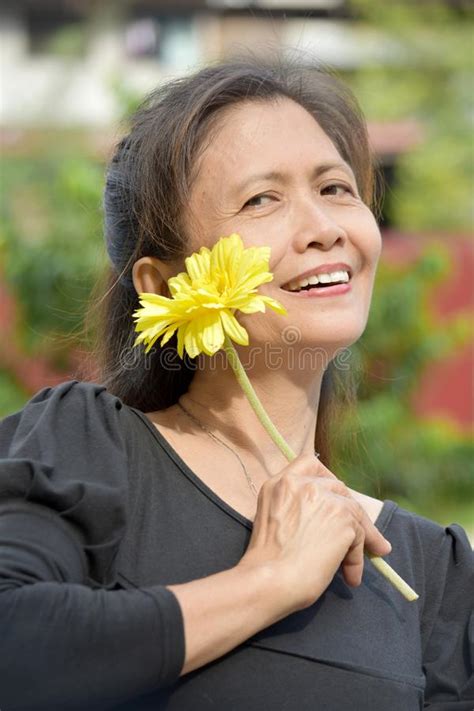 Filipina Female Senior Smiling With A Daisy Stock Image Image Of Citizen Mature 135762611