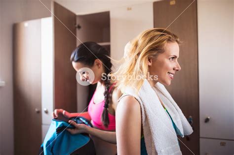 Two Attractive Fit Woman Changing In Locker Room In Gym Workout Clothes Royalty Free Stock