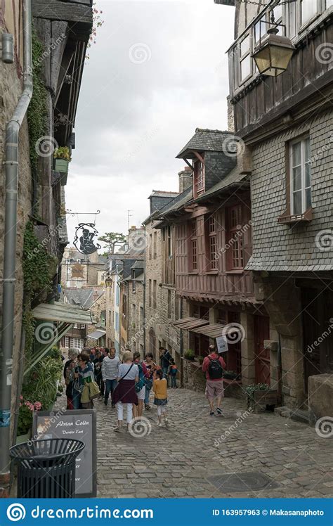 Tourists Enjoy A Visit To The Historic Old Town Of Dinan In Brittany