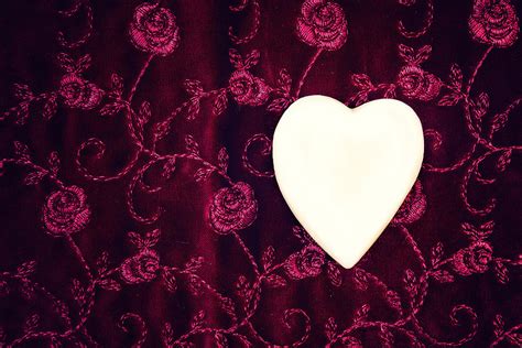 The shades of red suits are generally from dark red to medium red to red. White Heart Sits On A Red Velvet Background Photograph by ...