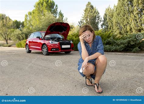 Desperate And Confused Woman Stranded On Roadside With Broken Car
