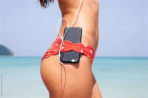 Beautiful Woman Are Listening Music On The Beach Del Colaborador De Stocksy Viktor Solomin