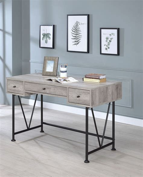 The heather gray desk features a full shelf for paperwork and supplies Guthrie Gray Driftwood Writing Desk from Coaster | Coleman ...