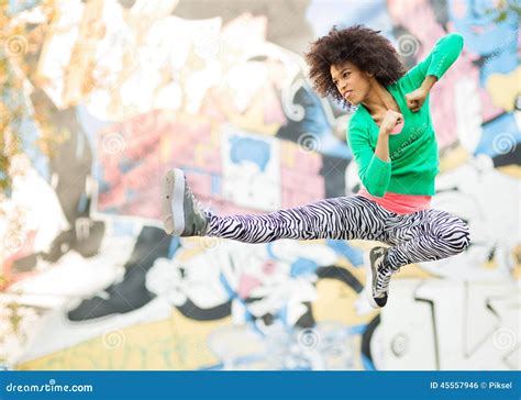 Young Woman Kicking In Mid Air Stock Photo Image Of Ethnicity