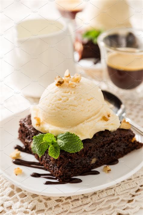 Chocolate Brownie With Vanilla Ice Cream Nuts And Mint Stock Photo