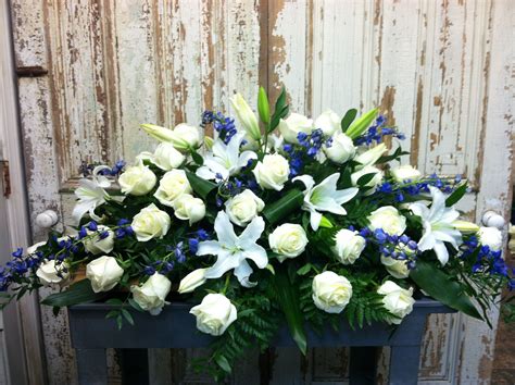 Casket Spray In Blue And White Roses Hybrid White Lilies And Electric