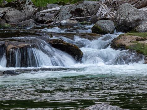 Fresh Clean Water Running Over Rocks Creating Small Waterfalls Stock