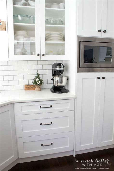 It features white shaker cabinets, black granite, and quartz countertops, marble mosaic backsplash with black hardware, an induction cooktop, and a paneled hood. The 25+ best White shaker kitchen cabinets ideas on Pinterest | Shaker style cabinets, White ...