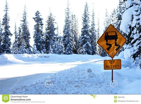 Icy Patches Road Warning Sign In Deep Snow Irony Ironic Stock Photo