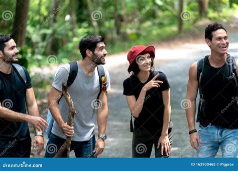 Group Of Friends Hiking Together Talk Happy While Hiking Up The