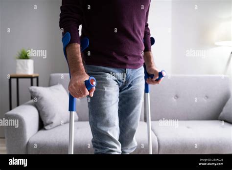 Elderly Man Using Crutches To Walk Stock Photo Alamy