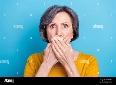 close up portrait of attractive worried puzzled middle aged woman closing mouth isolated over
