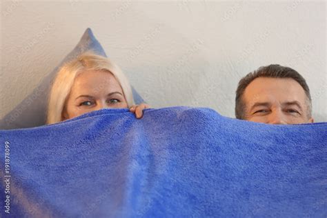 Senior Couple Hiding Under Blanket In Bed Together Stock 写真 Adobe Stock