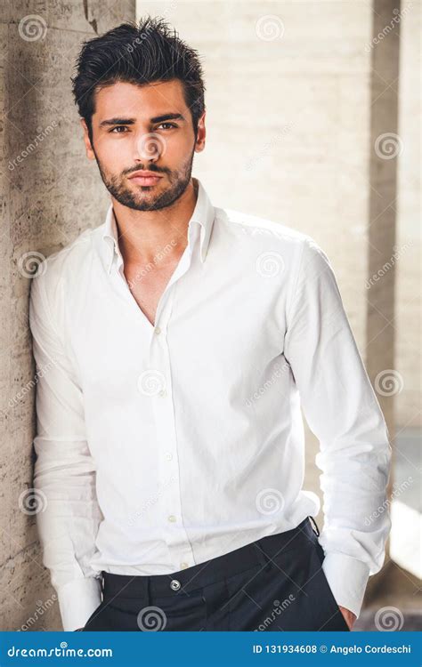 Portrait Of Young Handsome Man In White Shirt Outdoor Stock Photo