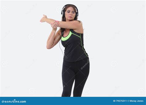 Attractive Middle Aged Woman In Sports Gear Wearing Over Ear Headphones