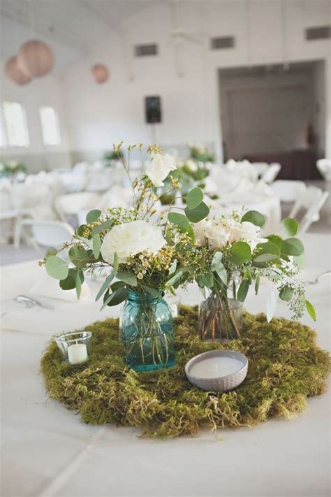 A moss table is a fun way of bringing a little bit of landscaping into your living room. Handmade Dairy Barn Wedding | Wedding centerpieces mason ...