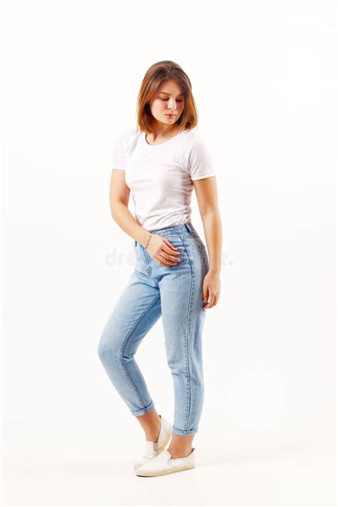 Beautiful Girl Teenager In White T Shirt And Jeans Poses Stock Image