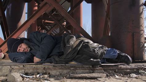 Homeless Senior Man In Jacket Sleeping Outside In Cold Weather In City