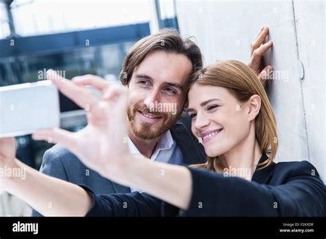 Portrait Of Two Business People Taking A Selfie With Smartphone Stock