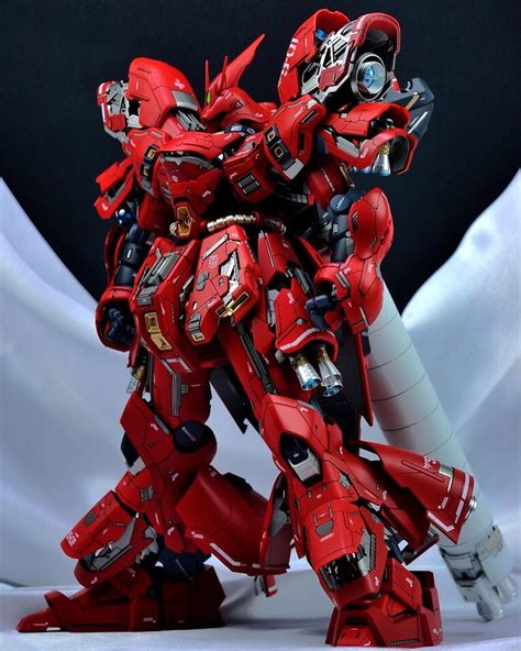 A Red And Black Robot Standing On Top Of A White Surface