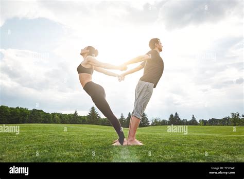 Yoga In Pair Beautiful Young Couple Practicing Acro Yoga Together And