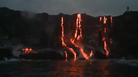 Lava Waterfalls Into The Pacific Ocean In Hawaii Au