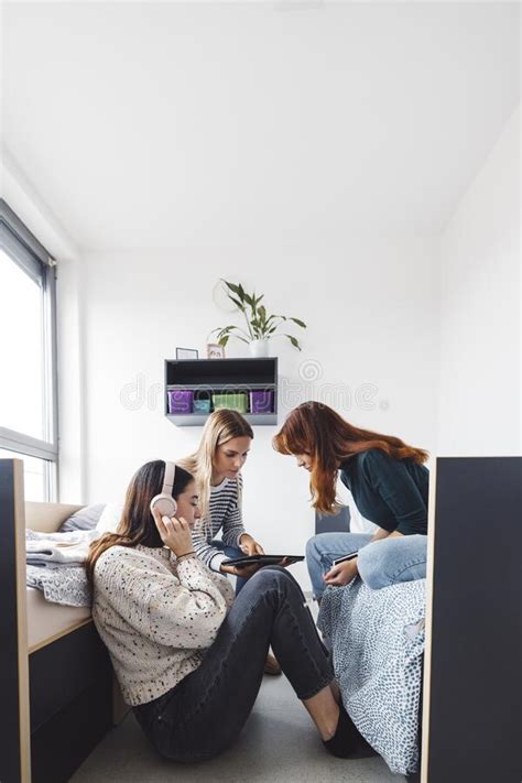 Vertical Photo Of Three Young Women Friends Spending Time Together In The Dorm Stock Image