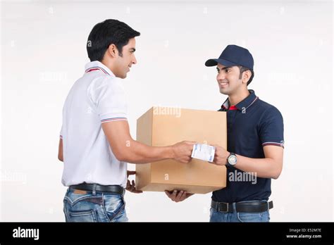Delivery man giving package to customer against white background Stock