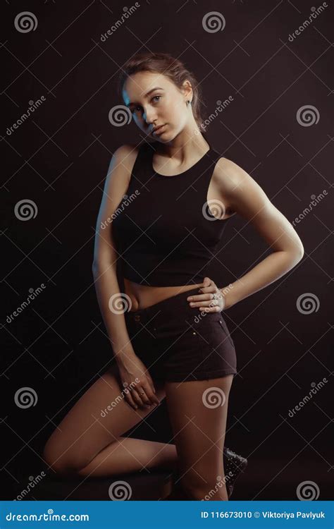 Studio Photo Session With A Beautiful Brunette Model Posing In T Stock