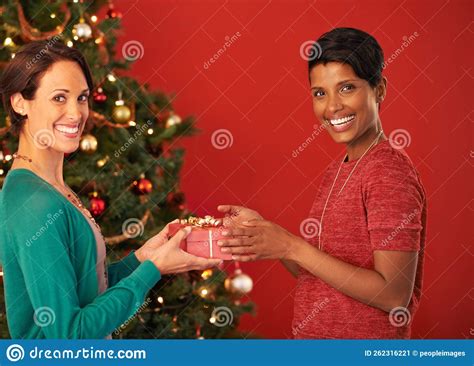 Exchanging Ts On Christmas Portrait Of Two Young Women Exchanging