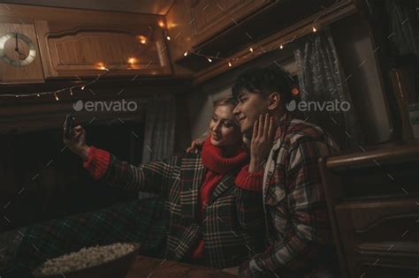 Candid Authentic Happy Married Couple In Love Taking Selfie From Mobile Phone At Night Motorhome