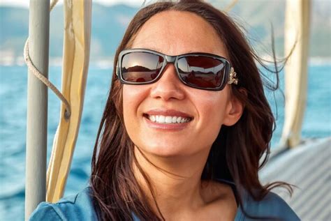 Premium Photo Young Woman In Sunglasses Smiles Enjoy Sailing On Boat