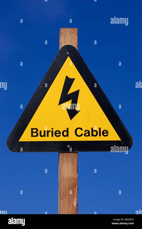 Yellow Buried Electrical Cable Warning Sign At A Quarry In The West