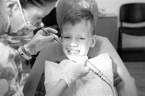 Premium Photo A Little Boy At A Dentists Reception In A Dental