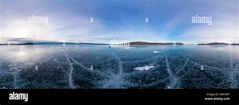 Blue Ice Of Lake Baikal Covered With Cracks Cloudy Weather Sunset