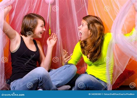 Two Teenage Girls Having Fun On The Bed Stock Image Image Of Fashionable Playing 34200383