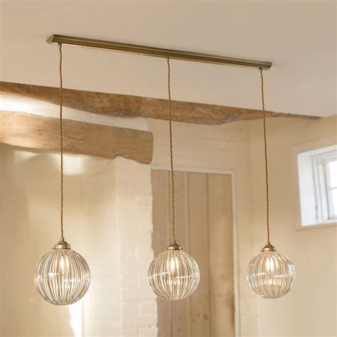 Fulbourn Triple Track Pendant In Antiqued Brass Pendant Lighting Over