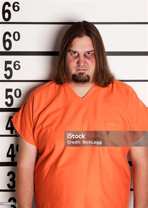 Mugshot Of A Large Man In Prison Uniform Stock Photo Download Image