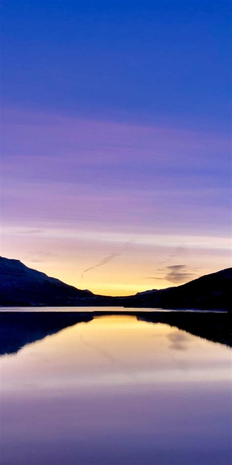 Download Wallpaper 1080x2160 Sunset Bluish Sky And Lake Mountains