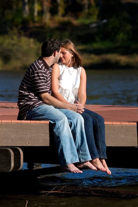 Young Couple In Love Sitting Barefoot On Dock Stock Image Image Of